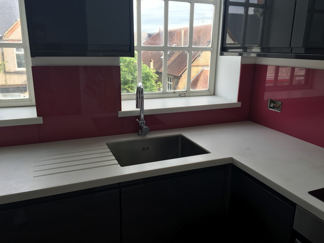 Deep plum coloured glass splashback in modern Dulwich kitchen